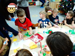 Rodzice z dziećmi robią świąteczne choinki