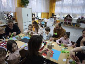 Rodzice z dziećmi wykonują wielkanocne ozdoby