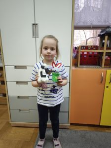dziewczynka pokazuje zrobione prace- baranka i zajączka